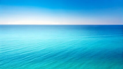 Obraz premium Vast ocean horizon with gentle waves under a clear blue sky