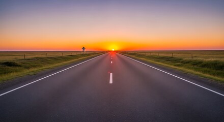 Scenic highway stretch leading to a vibrant sunset on the open plains landscape