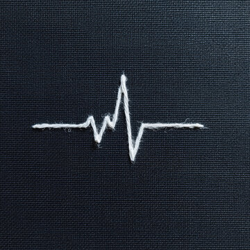 Isolated ECG graph on blue fabric showing disconnected heartbeat