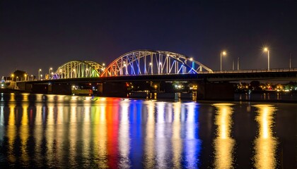 Naklejka premium Colorful bridge at night over water