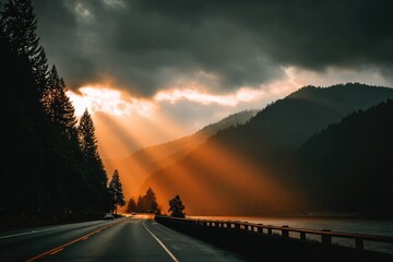 Sunbeams pierce dark clouds over a mountain road