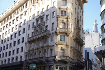 Historic building with ornate neoclassical architecture in downtown Buenos Aires, Argentina, with detailed balconies, large windows, and urban city surroundings under natural daylight.
