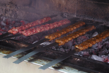 Grilling skewers over hot charcoal at a street vendor