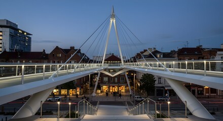 Naklejka premium Elegant pedestrian bridge in Amiens France spanning city streets at twilight hour showcasing