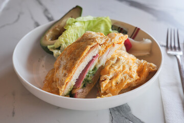 Delicious sandwich with avocado and fresh vegetables served