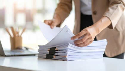 Businesswoman checking documents in office: organizing paperwork on desk