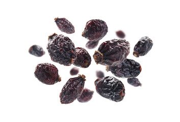 Dried rosehip berries levitate on a white background