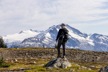 Hiker Admiring Snowy Mountain Vista in Whistler BC, Canada During Summer