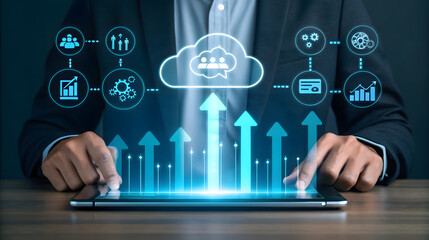 Businessman using tablet with glowing upward arrows and cloud icons