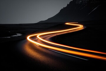Winding road at night, light trails