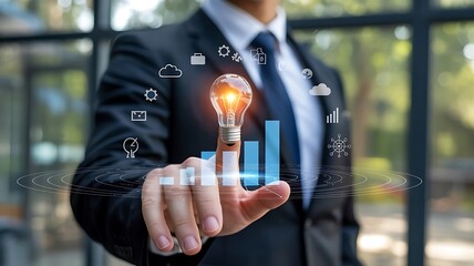 Business professional with glowing lightbulb and digital analytics