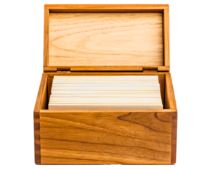 Open wooden recipe box filled with blank white index cards on a transparent background