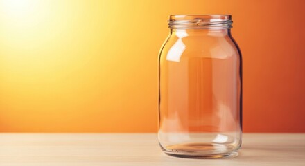 Empty glass jar a wooden table with an orange, perfect for showcasing food preservation or storage concepts