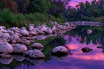 Calm riverbank at sunset, reflections of vibrant colors