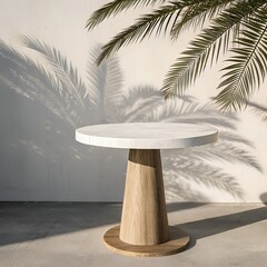 A round white table with a wooden base under palm tree with shadows wall