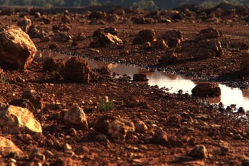 Dry, rocky terrain with a shallow water run