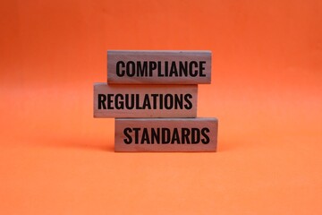 Stacked Blocks Displaying Compliance Regulations and Standards in Business Environment. isolated on...