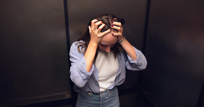 Female Elevator Technician Comforts Woman Trapped