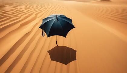A black umbrella casting a shadow on the sand dunes in a desert landscape with rippled sand texture