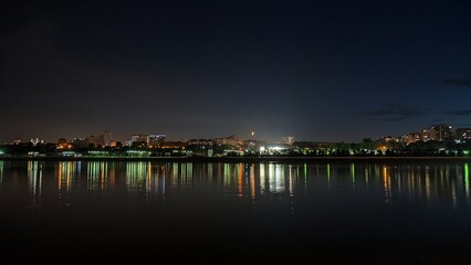 Obraz premium Bright Moon above the night city and river