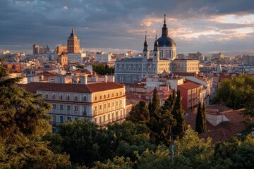 Obraz premium Spectacular sunset illuminates the skyline of Madrid, Spain showcasing historic architecture and vibrant city life