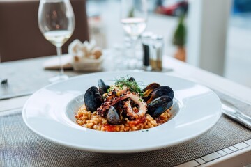 Delicious seafood risotto featuring fresh mussels served in a stylish restaurant setting for a delightful dining experience