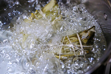 Zongzi boiling in a pot. Traditional Chinese food