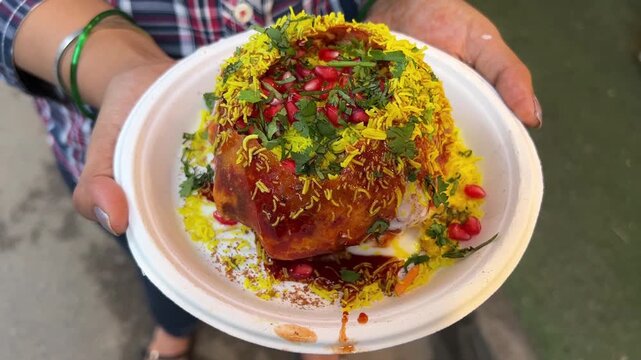 Spicy Raj Kachori prepared with pomegranate, bhujia, tomato chutney, potato and coriander. 