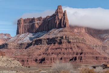 Red rock mesa with snow and clouds