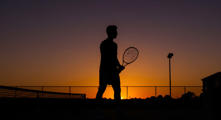 Silhouette of a tennis player at sunset (2)