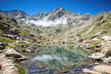 Mountain lake, hikers, serene valley