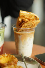 Closeup of Iced Caramel Macchiato at the coffee shop, Caramel Macchiato is a classic macchiato beverage. It consists of vanilla syrup, espresso, steamed milk, foam, and caramel drizzle