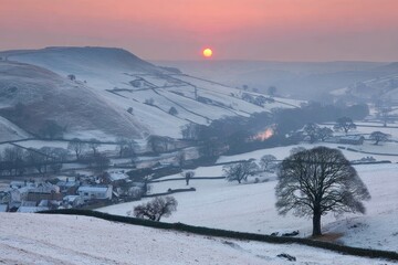 Winter sunrise over a snowy valley
