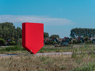 Physical red shield in rural landscape perfect for environmental and countryside branding overlay