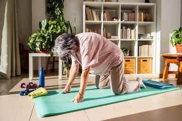 Old Lady Practicing Cat Cow Pose at Home for Flexibility and Well-Being