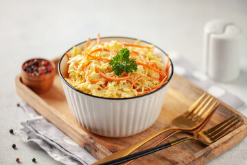 Cabbage and carrots salad coleslaw in a bowl on a table.