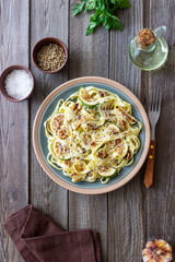 Fettuccine pasta with zucchini, nuts and parmesan cheese. Healthy eating. Vegetarian food. Italian cuisine.