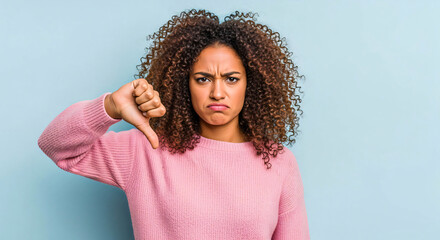 Disapproval: Young Woman with Thumbs Down Gesture