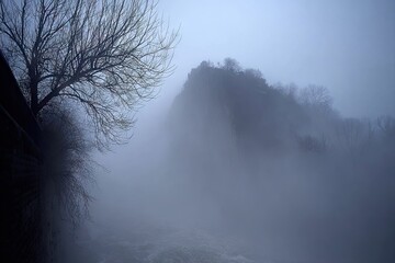 Misty riverbank landscape at dawn