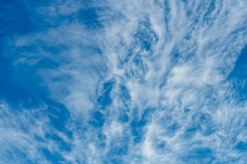 High cloud in the blue afternoon sky