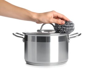 Cleaning a stainless steel pot with a scouring pad