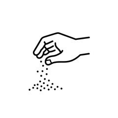 Hand sprinkling small particles or seeds