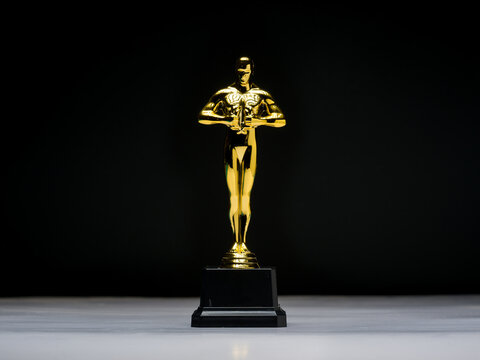 Antalya, Turkey - July 21, 2025: Golden Oscar award statue with black background