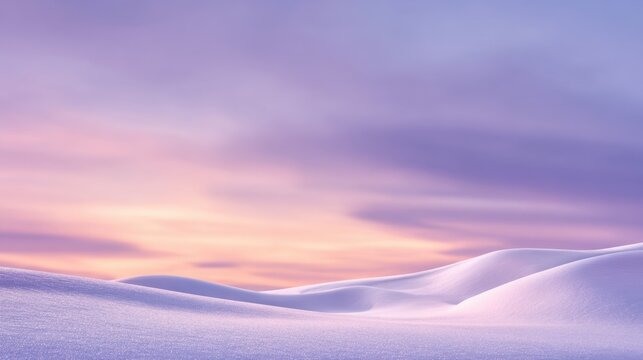 The serene beauty of snow-covered hills under a pastel sunset sky.