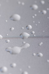metal surface covered with water, wet silver metal painted to protect aluminum alloy and metals, close up