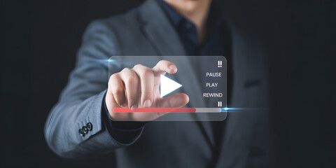 Confident businessman engages with futuristic digital interface, activating media playback with a touch.