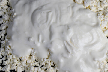 sprinkled with liquid sour cream, lumps of freshly made fermented milk product, close up