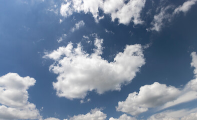 blue sky with clouds in sunny weather, blue sky with cumulus clouds illuminated by sunlight