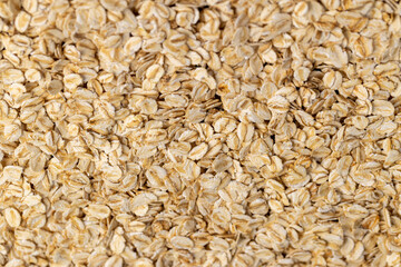 oat flakes from oatmeal , a large amount of oat flakes for quick cooking of porridge in boiled hot water, closeup
