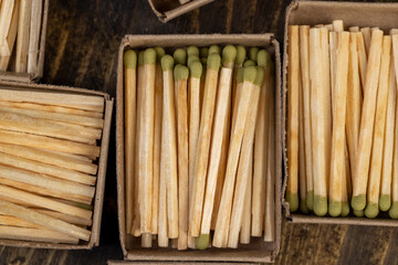 matches in matchbox, the green head of a wooden match laid out in cardboard boxes
